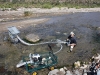 Ray using a dredge in a riverbed under the rocks